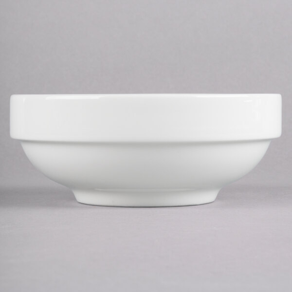 A Homer Laughlin bright white bowl with a white rim on a gray surface.