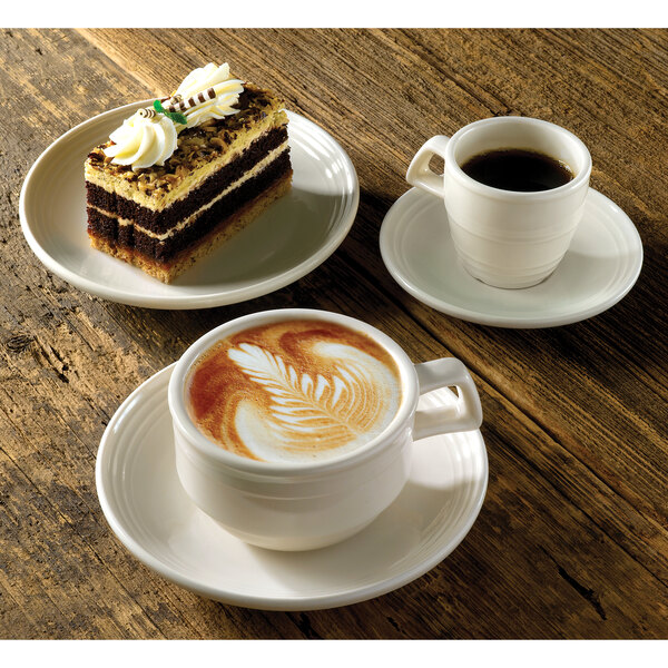 A Homer Laughlin ivory china cup of coffee on a saucer with a piece of cake.