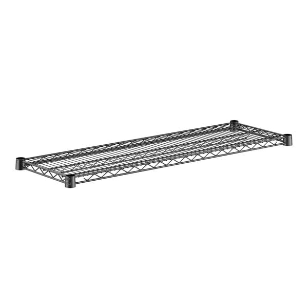 A close-up of a black metal wire shelf.