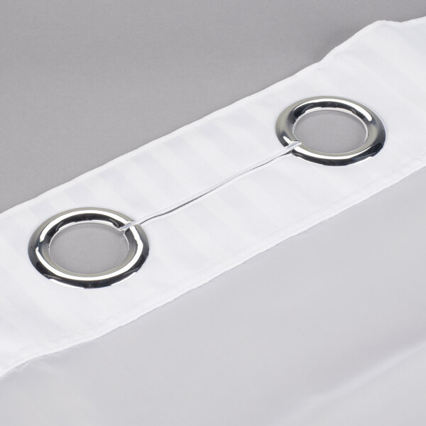 A Hookless white shower curtain with chrome rings hanging on a rod.
