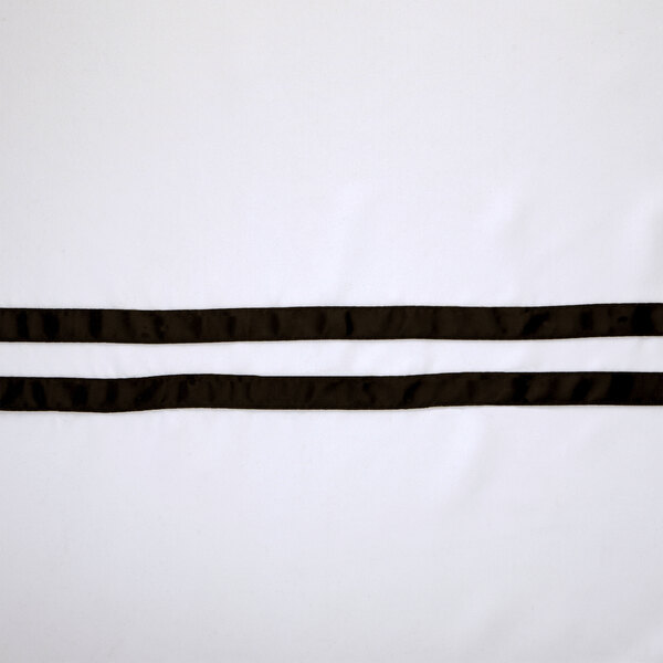 A black and white striped fabric with a white ribbon.