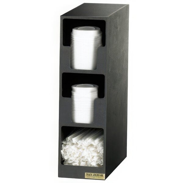 A black San Jamar countertop lid organizer with white plastic cups and straws in the compartments.