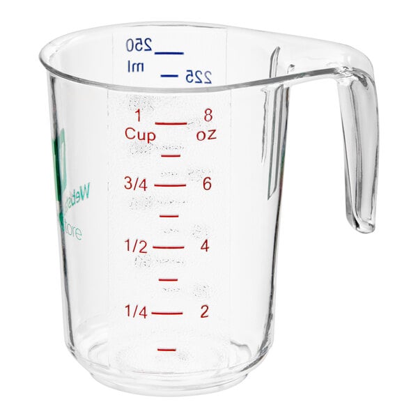 A clear plastic measuring cup with red and blue measurements.