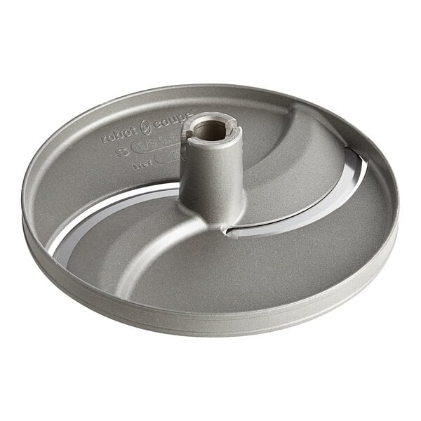 A grey circular metal object with a hole in the center.