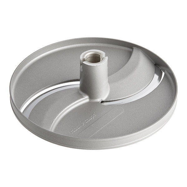 A silver circular Robot Coupe slicing disc with a hole in the center.