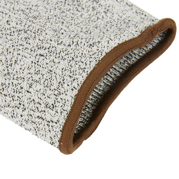 A close up of a gray knit glove with brown polyurethane coating.