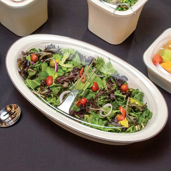 A Carlisle Clear lid on a bowl of salad with green vegetables.