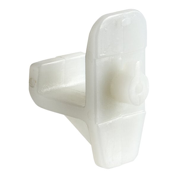 A white plastic Turbo Air shelf clip with a small hole.