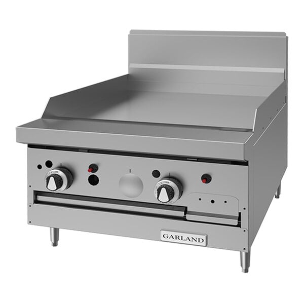 A commercial stainless steel natural gas griddle range with control knobs and a 24-inch cooking surface.