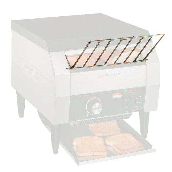 A Hatco TQ Series conveyor toaster with a Hatco TQRAMP feed guide over two slices of toast.