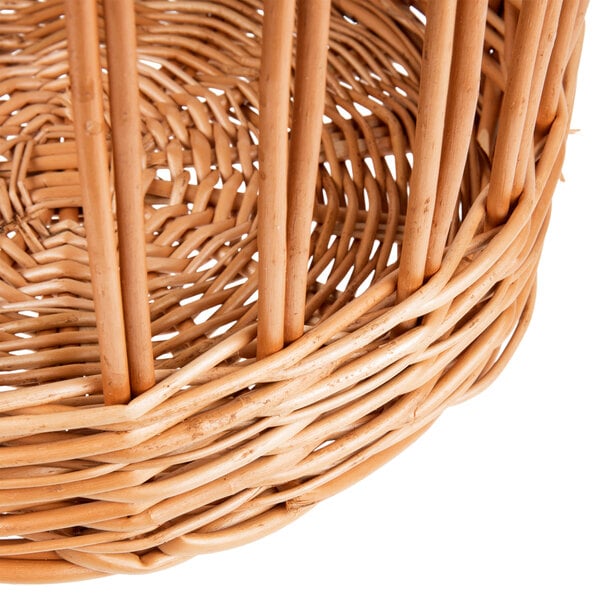 A Matfer Bourgeat round wicker bread basket with a handle.