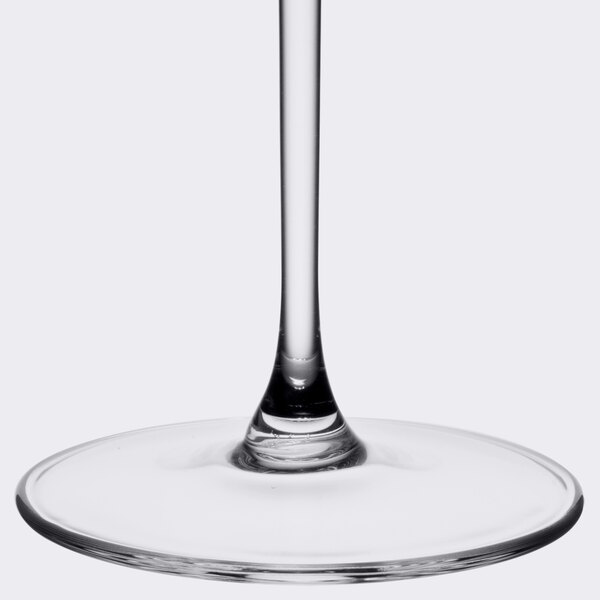 A clear wine glass with a thin stem.