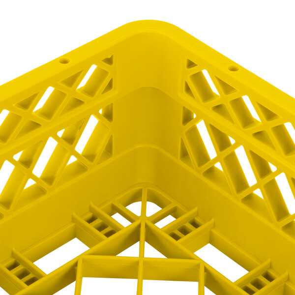 A yellow Vollrath Traex dish rack with extenders and a handle.