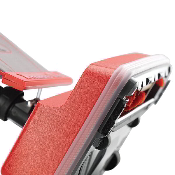 An Oreck upright bagged vacuum cleaner with red and black accents.