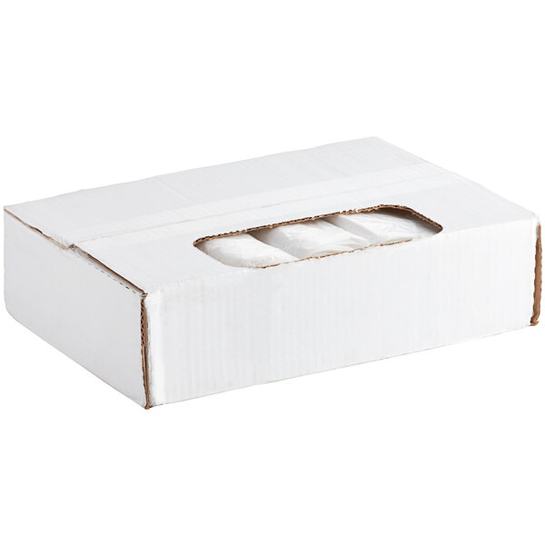 A white box with three white rolls of Lavex janitorial trash bags inside.