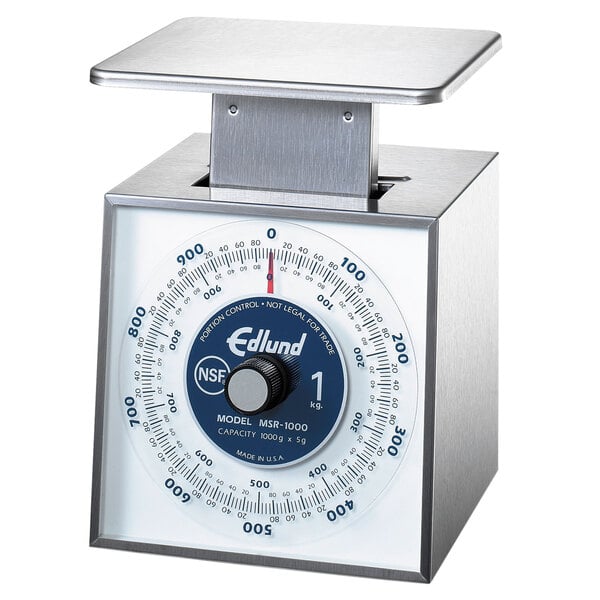 A silver and blue Edlund stainless steel portion scale on a counter.