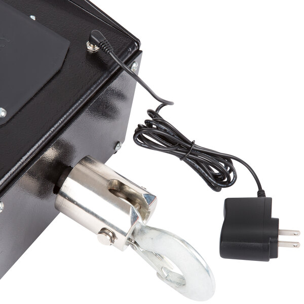 A Tor Rey CRS1000/2000 digital crane scale black box with a metal cylinder and a hook attached.