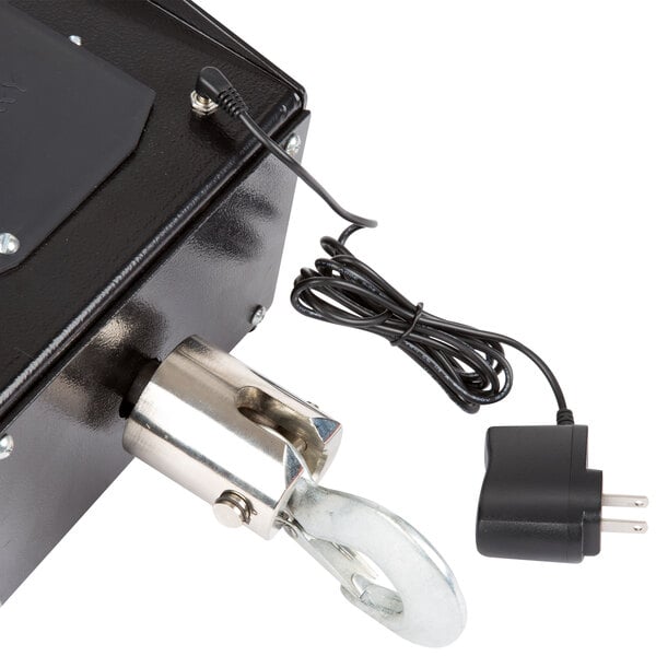 A close-up of a black and silver Tor Rey digital crane scale with a metal hook.