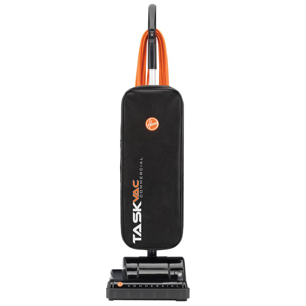 A black and orange Hoover Task Vac commercial bagged vacuum cleaner.