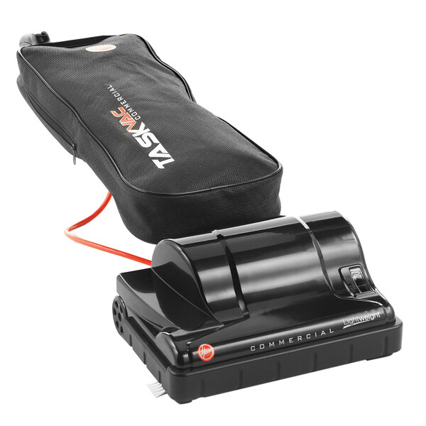 A black Hoover Task Vac commercial bagged vacuum cleaner with a red cord.