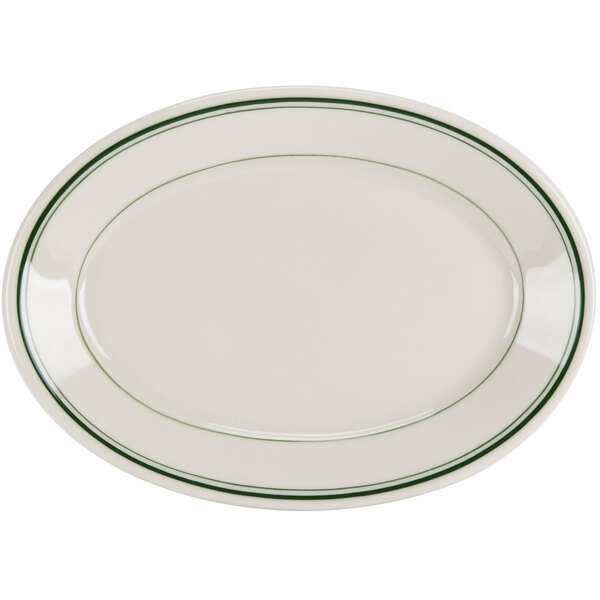A white oval platter with green bands on the rim.
