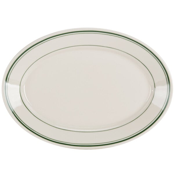A white oval platter with green stripes on the rim.