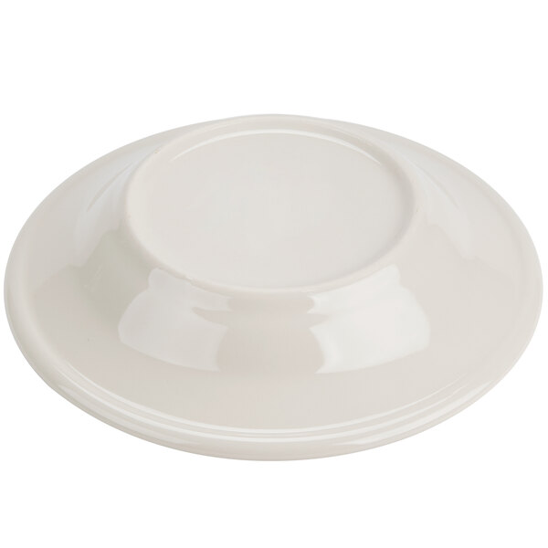 A close-up of a Homer Laughlin soup bowl with a green band on the rim.