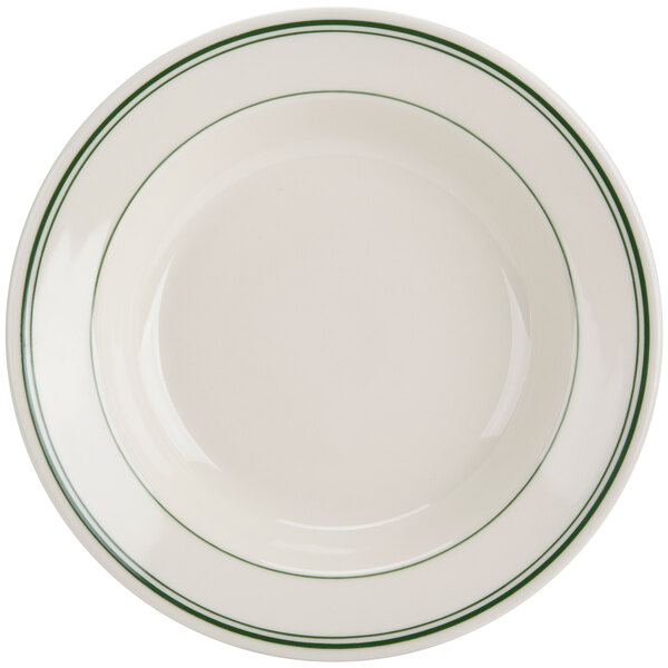 A close up of a white Homer Laughlin soup bowl with green lines on the rim.