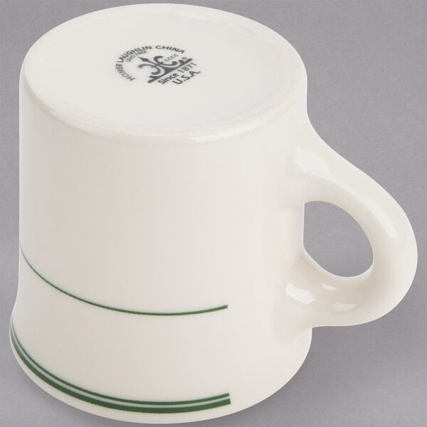 A white mug with green stripes on the rim.