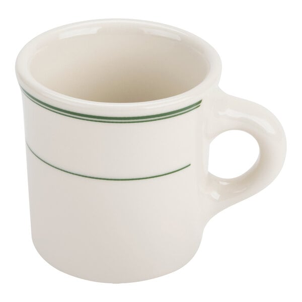 A white ceramic mug with two green bands around its upper half and a large handle.