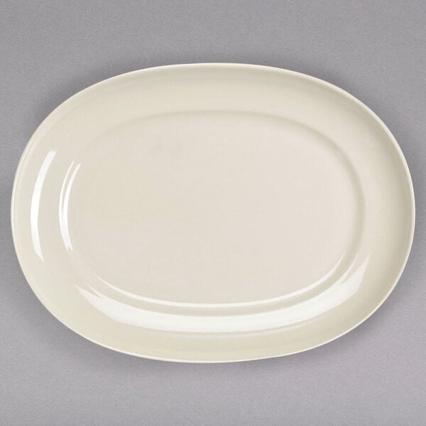 A white oval Homer Laughlin china platter on a gray surface.