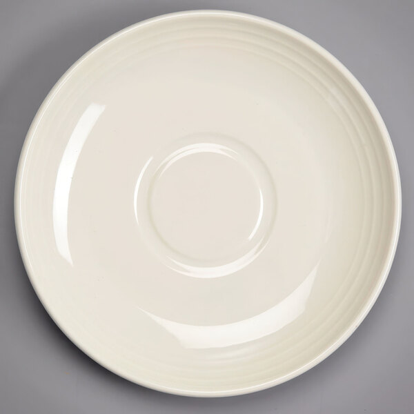 A white Homer Laughlin saucer with a circular edge.