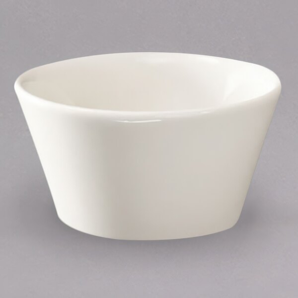 A white Homer Laughlin china bouillon cup on a gray surface.