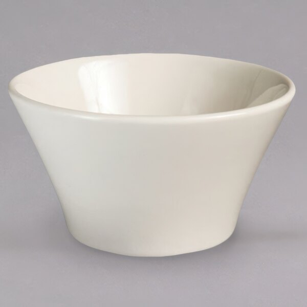 A white bowl with a curved edge on a white background.