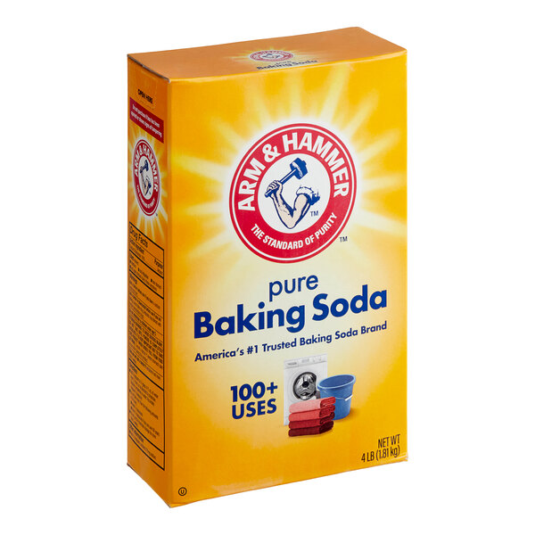 A yellow Arm & Hammer box of baking soda on a kitchen counter.