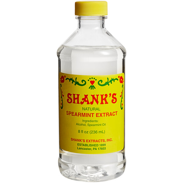 A bottle of Shank's Pure Spearmint Extract on a counter.