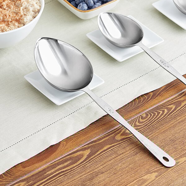 An American Metalcraft stainless steel spoon with a bowl of oatmeal and blueberries on a white plate.
