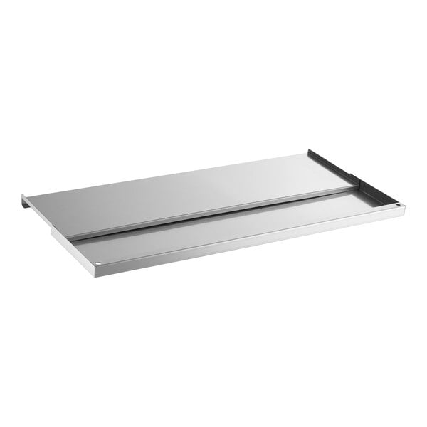 A rectangular, flat, stainless steel sliding lid with raised edges on three sides.
