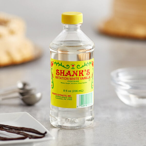 A bottle of Shank's White Imitation Vanilla extract on a table.