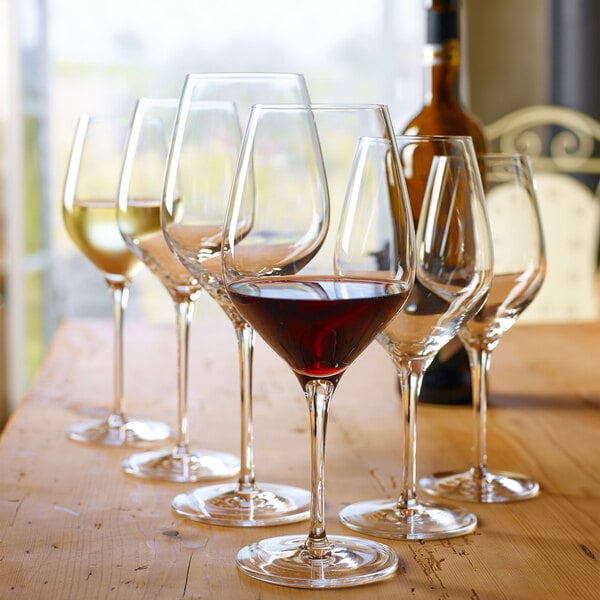 A group of Stolzle Exquisit flute wine glasses on a table.