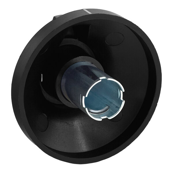 A black circular object with a metal tube inside.