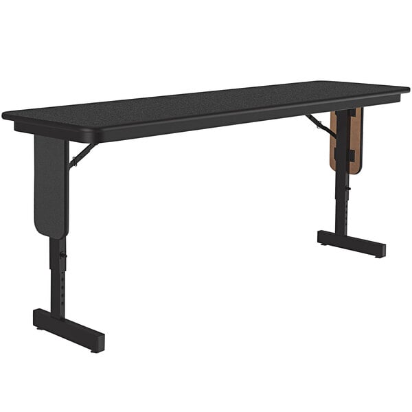 A black rectangular Correll seminar table with panel legs.