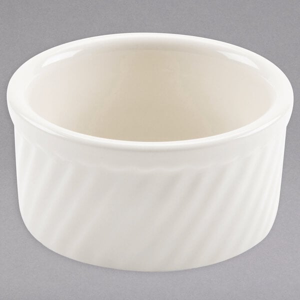 A white Hall China souffle dish with a wavy pattern.