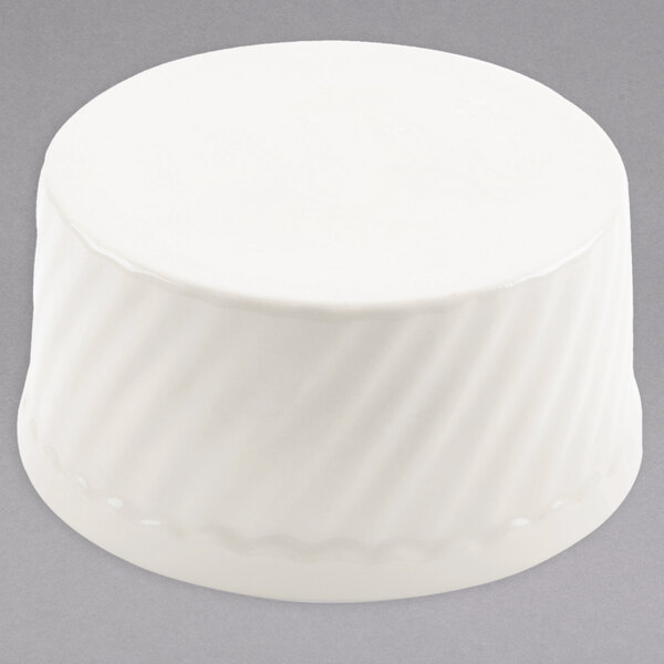A white round Hall China souffle dish with a wavy pattern.