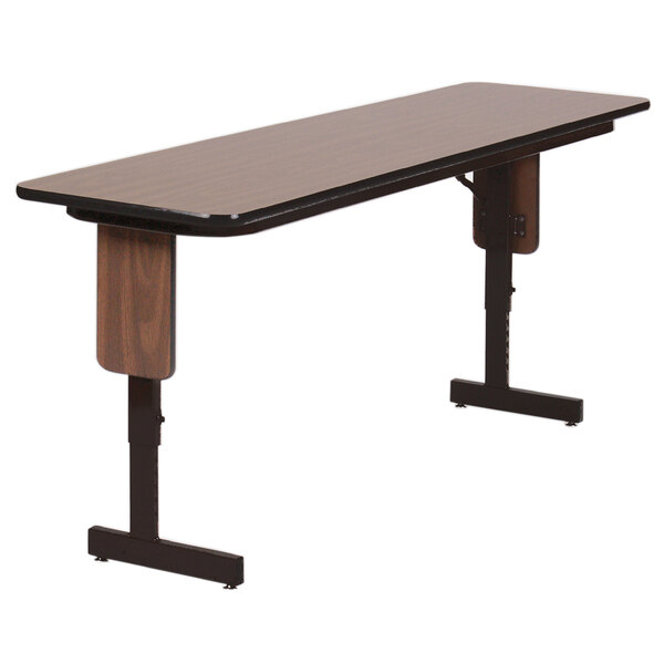 A rectangular Correll seminar table with a walnut surface and black panel legs.