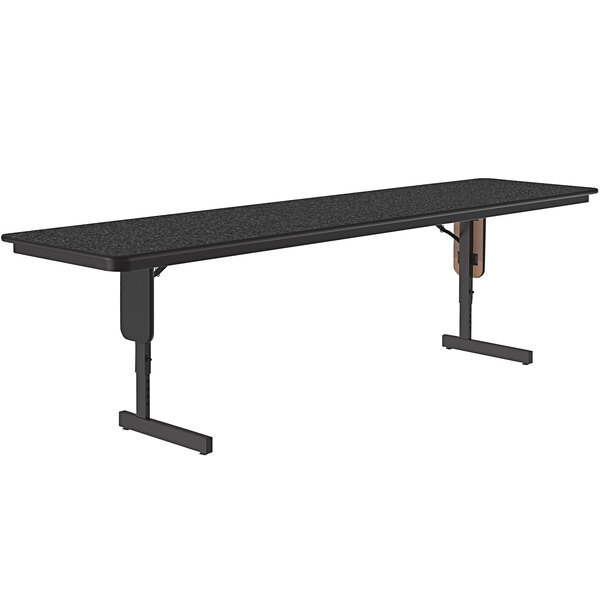 A rectangular Correll seminar table with a black granite surface and panel legs.