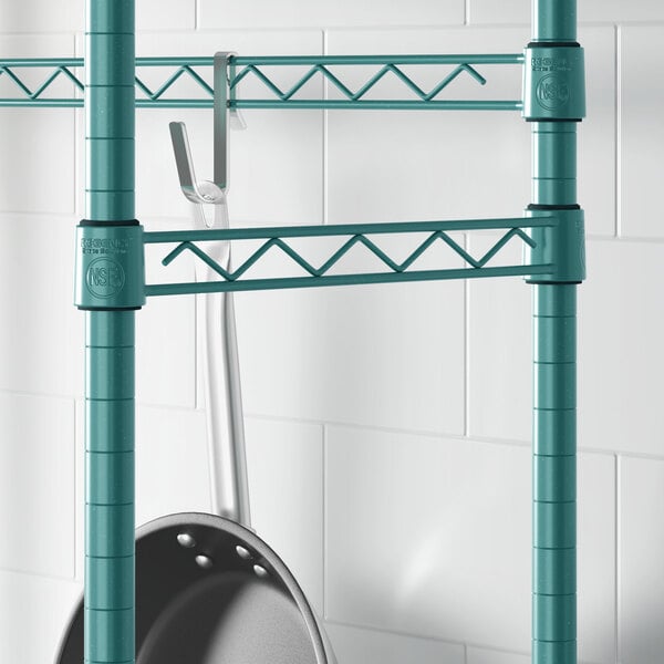 A Regency green epoxy hanger rail holding a metal pan.
