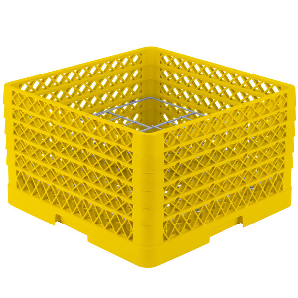 A yellow plastic Vollrath Traex Plate Crate with 12 compartments and holes on the top.