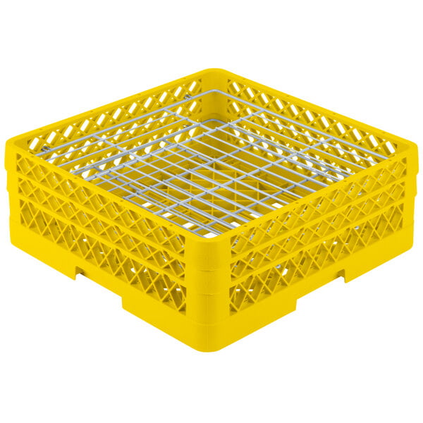 A yellow plastic Vollrath Traex plate rack with metal dividers.