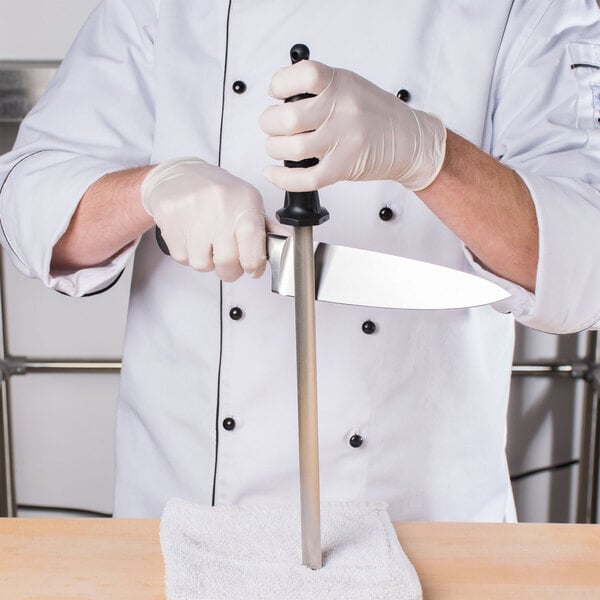 Chef using a sharpening steel on a knife